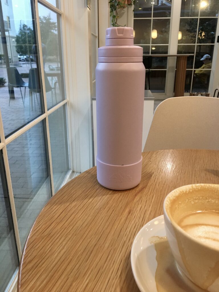 Hydrapeak water bottle sitting on a table in a coffee shop. 