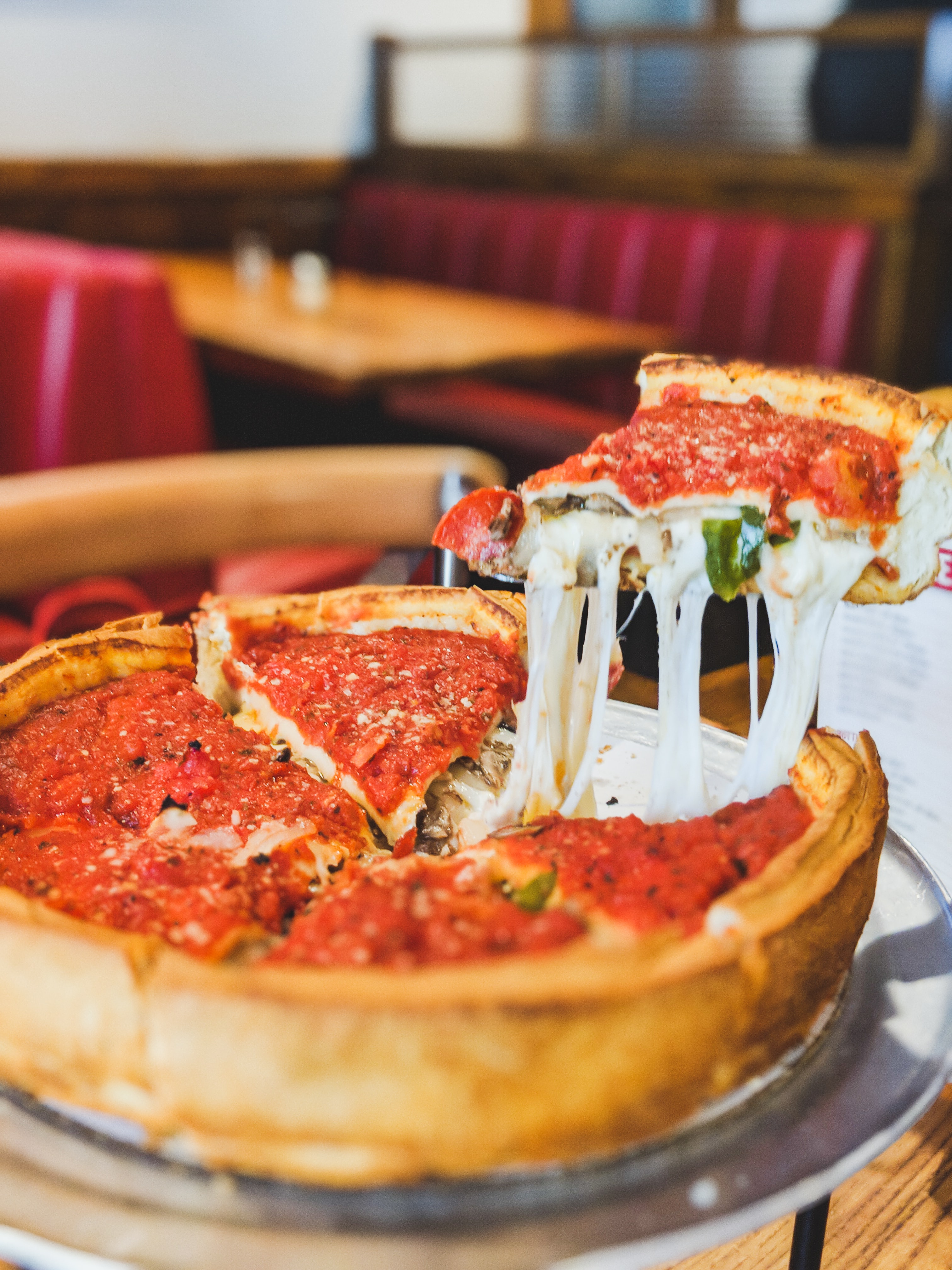 A huge slice of deep dish Chicago pizza. 