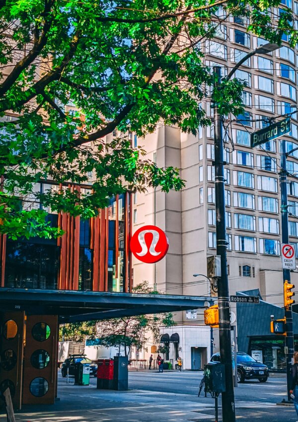 Lululemon store logo in a city scape. Lululemon Dance Studio Joggers Fit Review vs. On The Fly Joggers Fit Review.