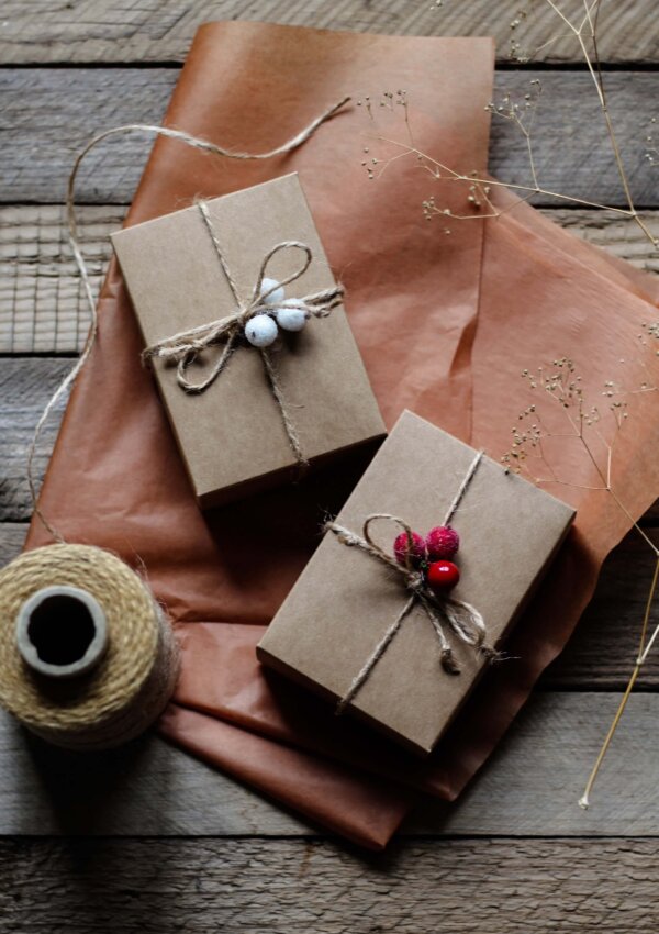 10 Amazing gift ideas. Two presents wrapped in cute brown paper sitting on a tissue paper.