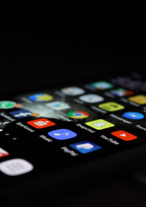 phone in a dark room with all the social media apps highlighted. Social Media Detox.