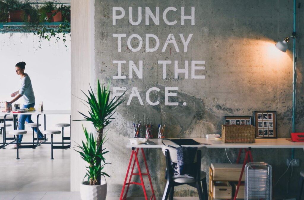 A sign on a wall that says Punch Today in the Face. What are SMART goals. 